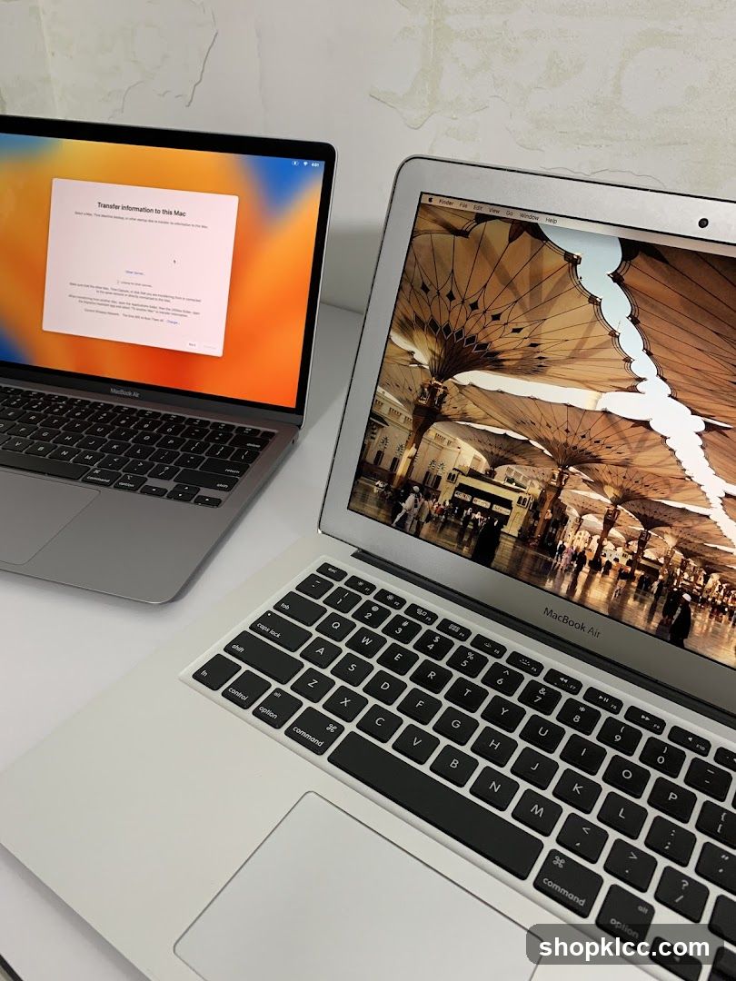 Two MacBook Air laptops on a white surface