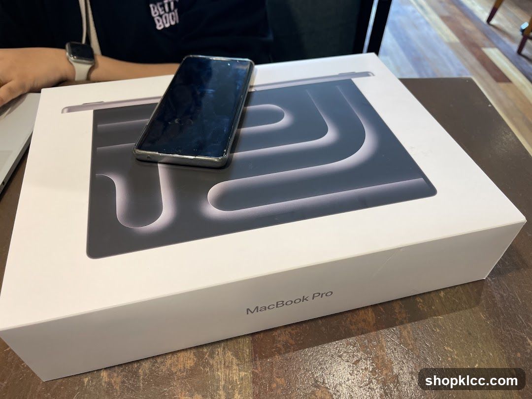 MacBook Pro Box with iPhone on Top