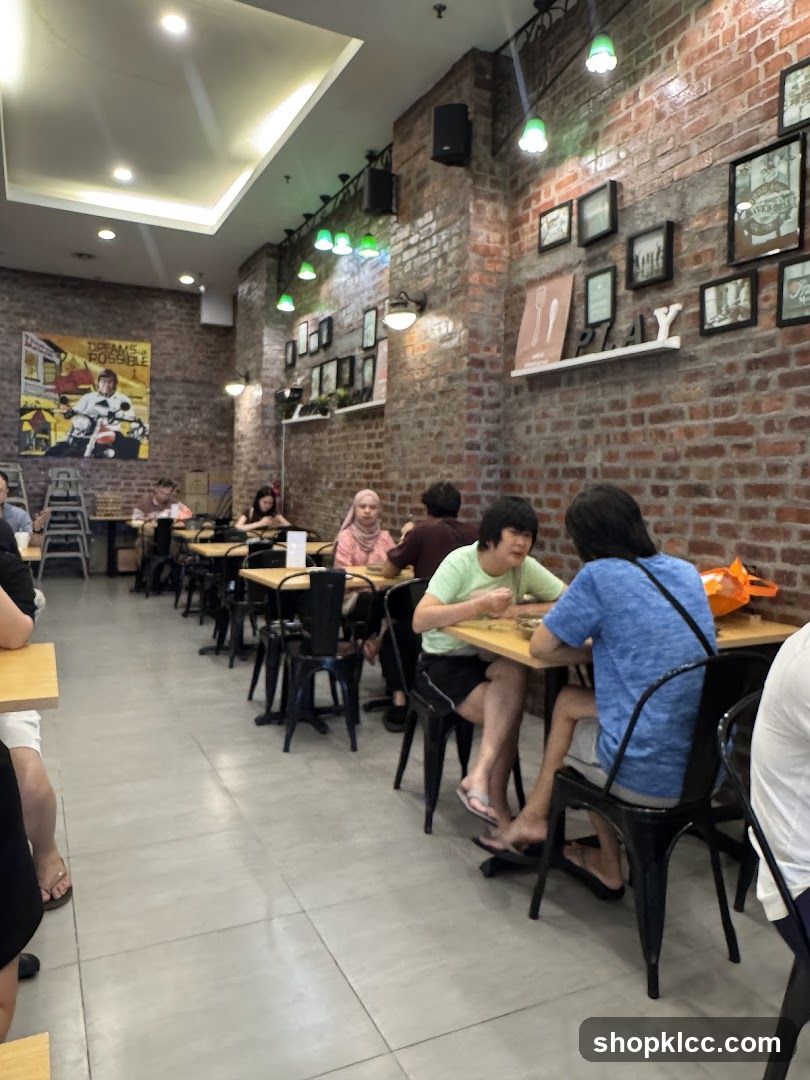 Interior of a casual dining space with brick walls and patrons at tables.