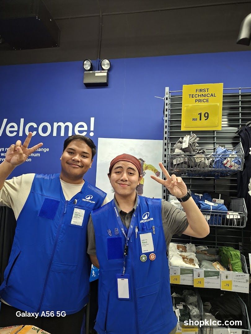 Staff in blue vests posing inside store