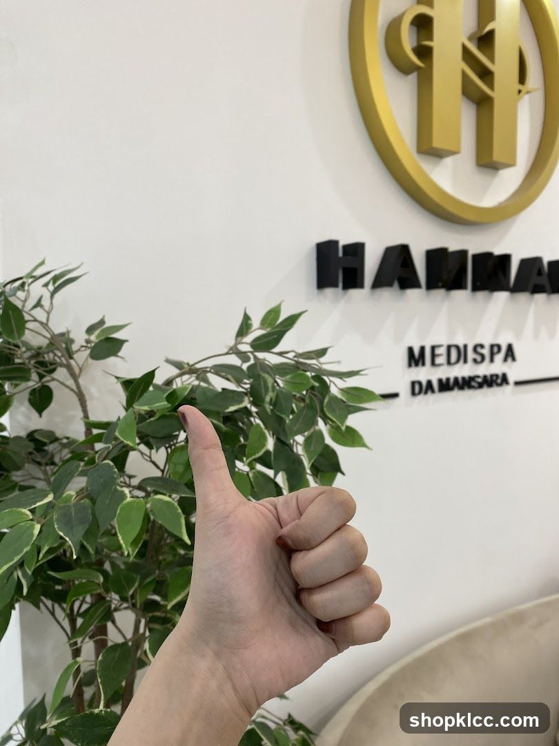 Hand giving thumbs up near Medispa signage