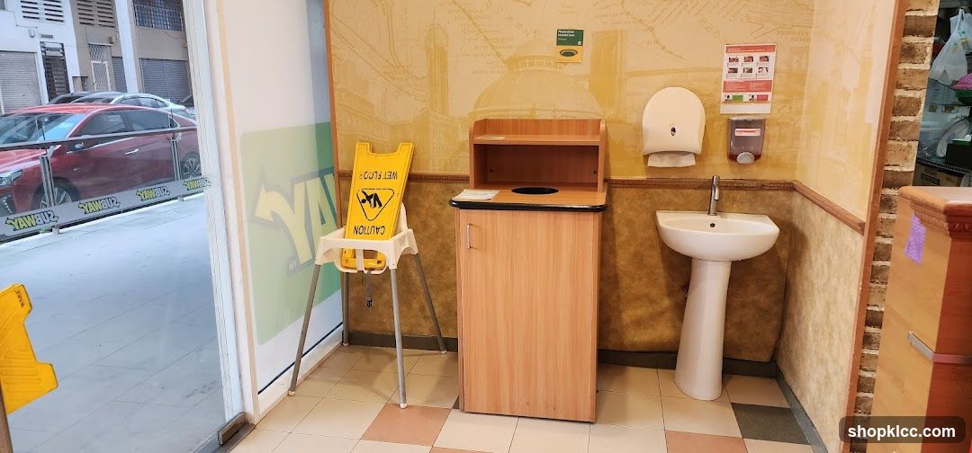 Restroom Area with Sink and Trash Bin