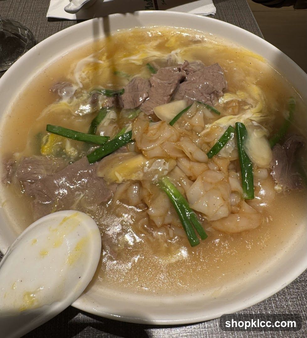 Bowl of Noodle Soup with Meat and Greens