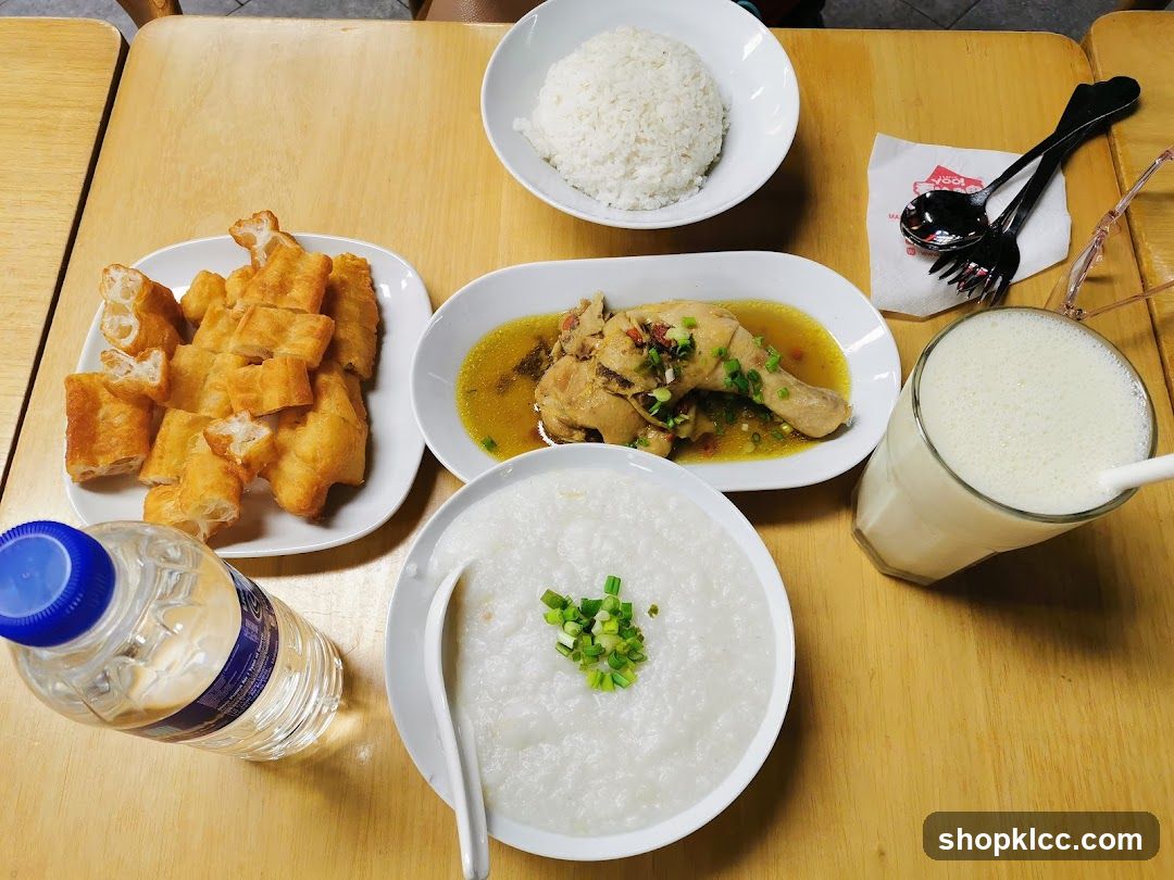 Breakfast Spread with Rice, Chicken, Fried Dough, Porridge and Drink