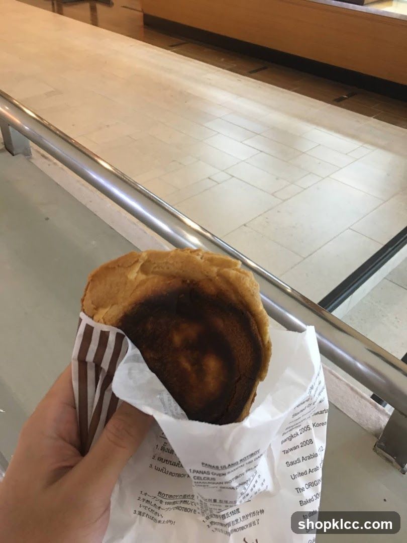 Hand holding a burnt pastry