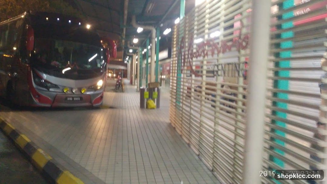 Bus at night with closed shop fronts