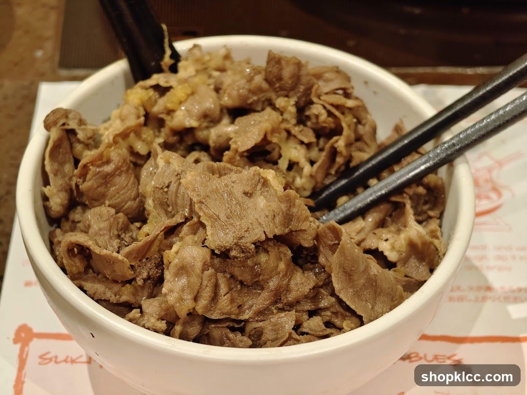 Bowl of cooked beef with chopsticks