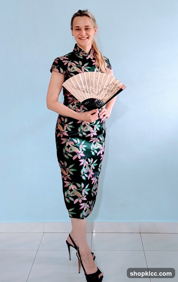 Woman in Floral Cheongsam with Fan