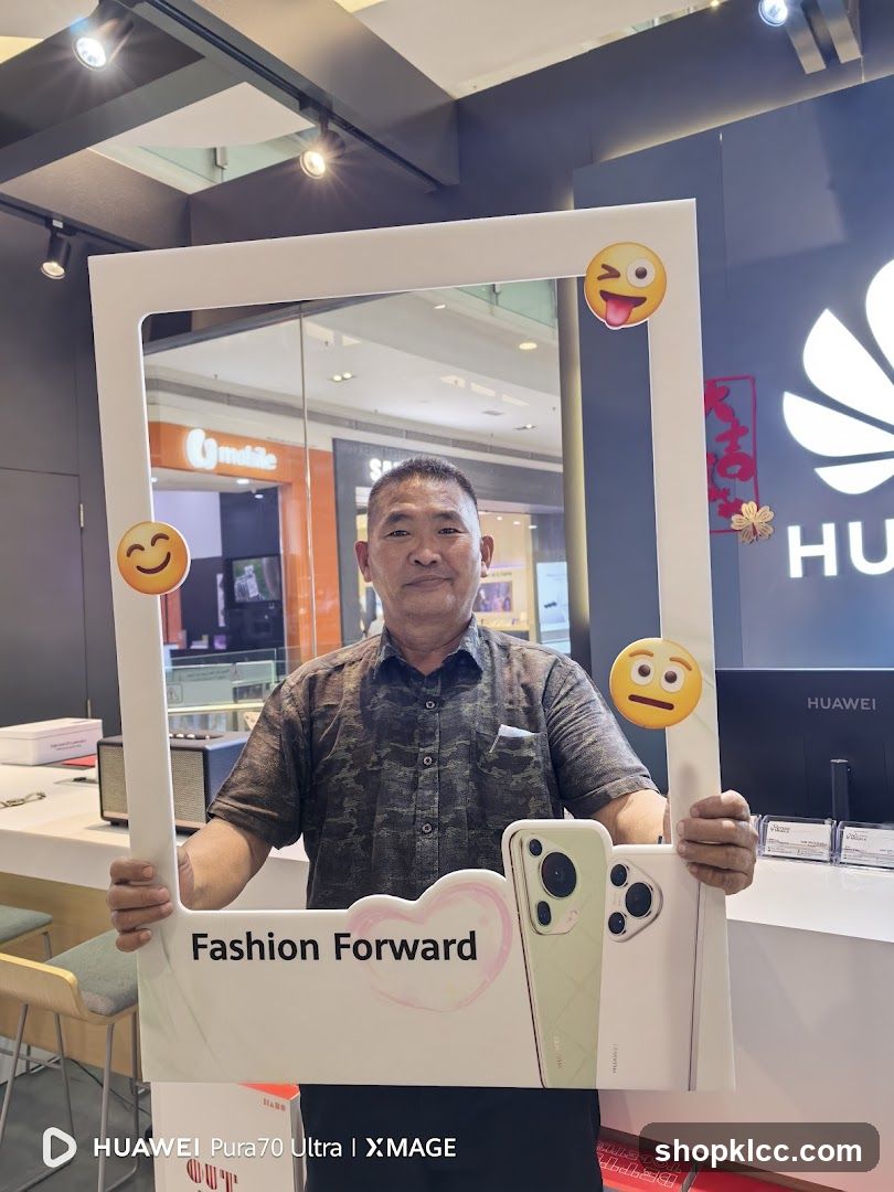 Man Posing with Huawei Photo Frame