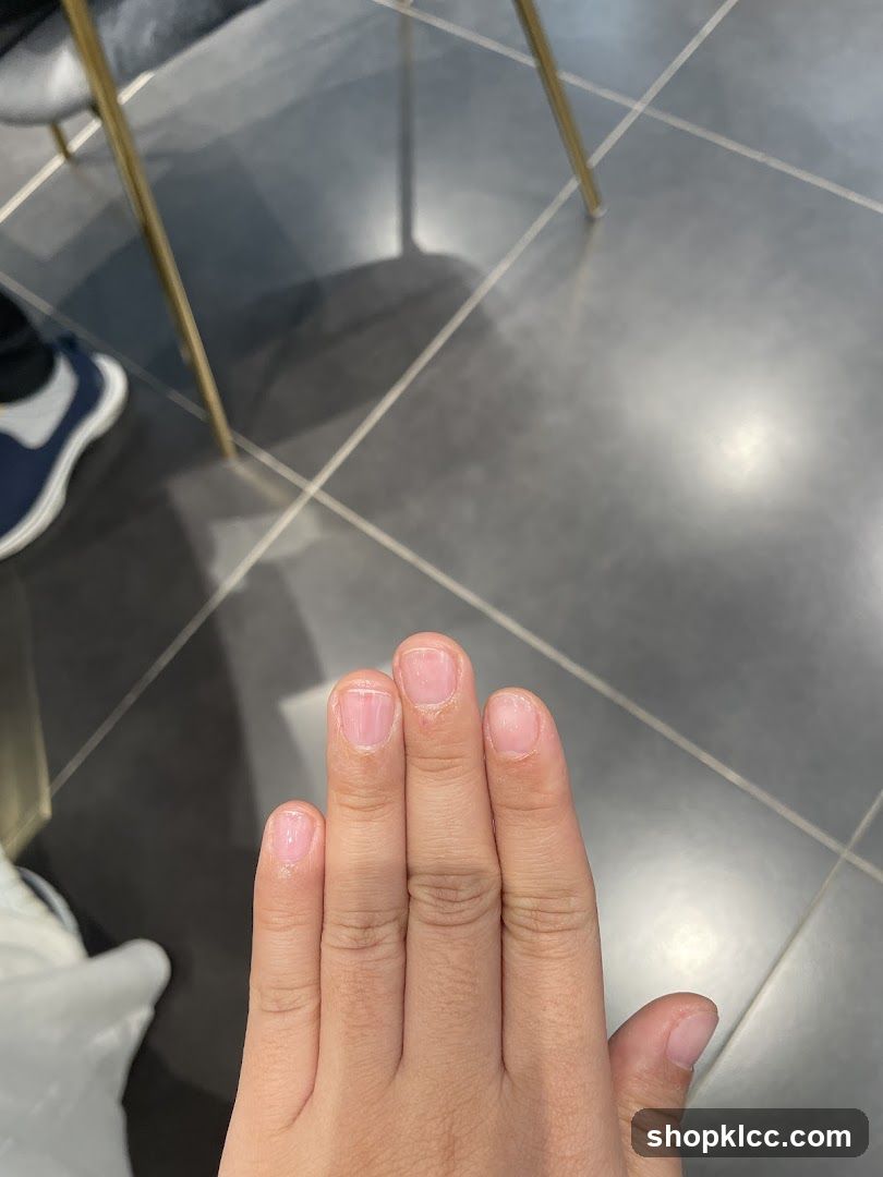 Hand with freshly painted nails