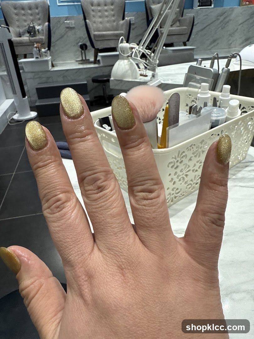 Manicured Hand with Gold Glitter Polish