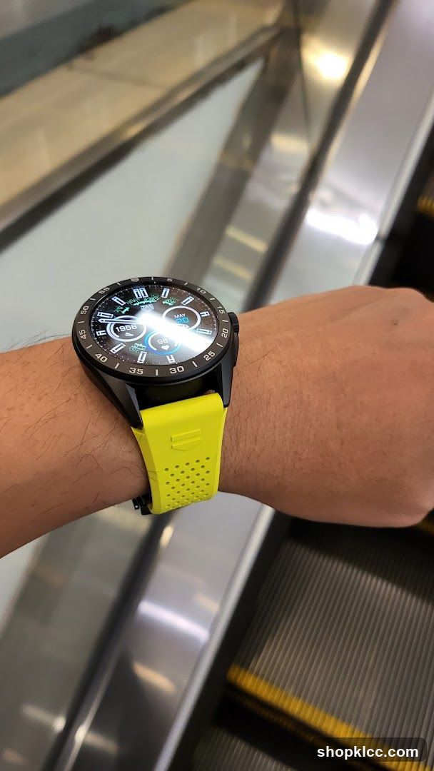 Smartwatch on wrist near escalator