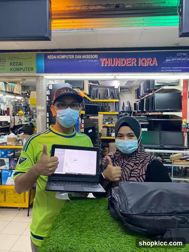 Tech Store Staff with Laptop