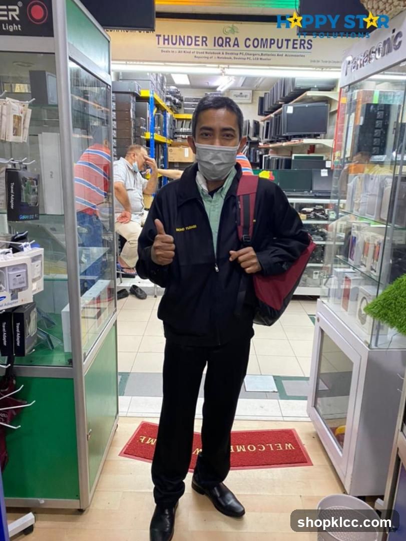Man Giving Thumbs Up in Electronics Store