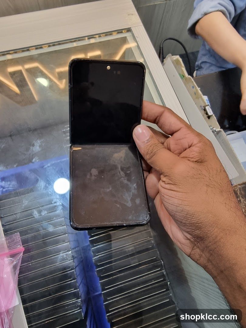 Hand holding damaged phone