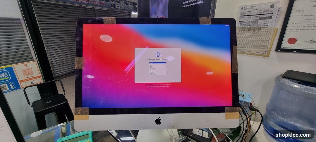Apple iMac on desk in shop interior
