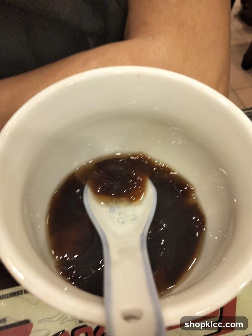 Bowl of dark sauce with spoon