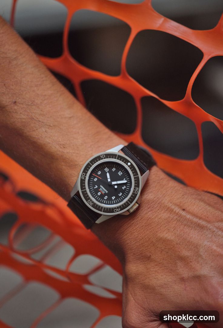 Watch on wrist with orange safety net background
