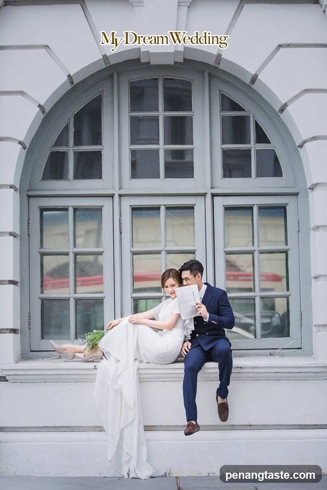 Couple Posing in Front of Large Window