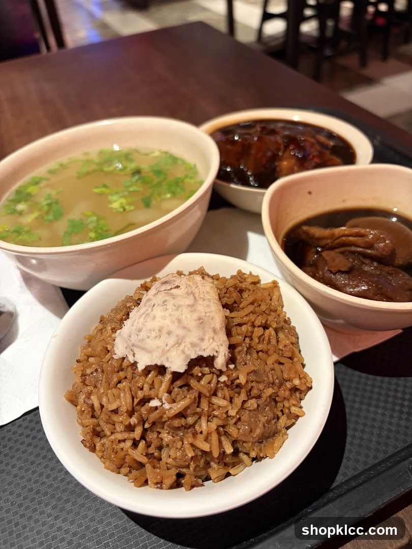 A meal with rice, soup, and braised dishes