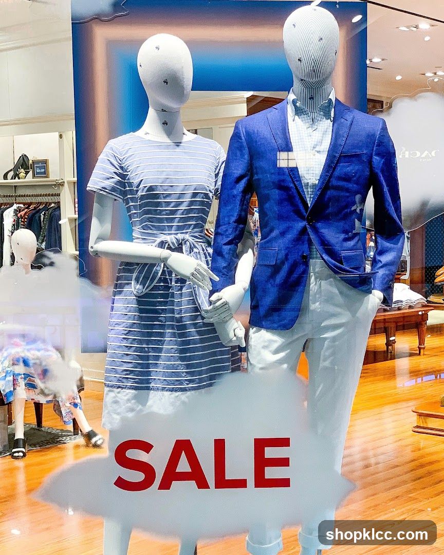Store Window Display with Mannequins and Sale Sign