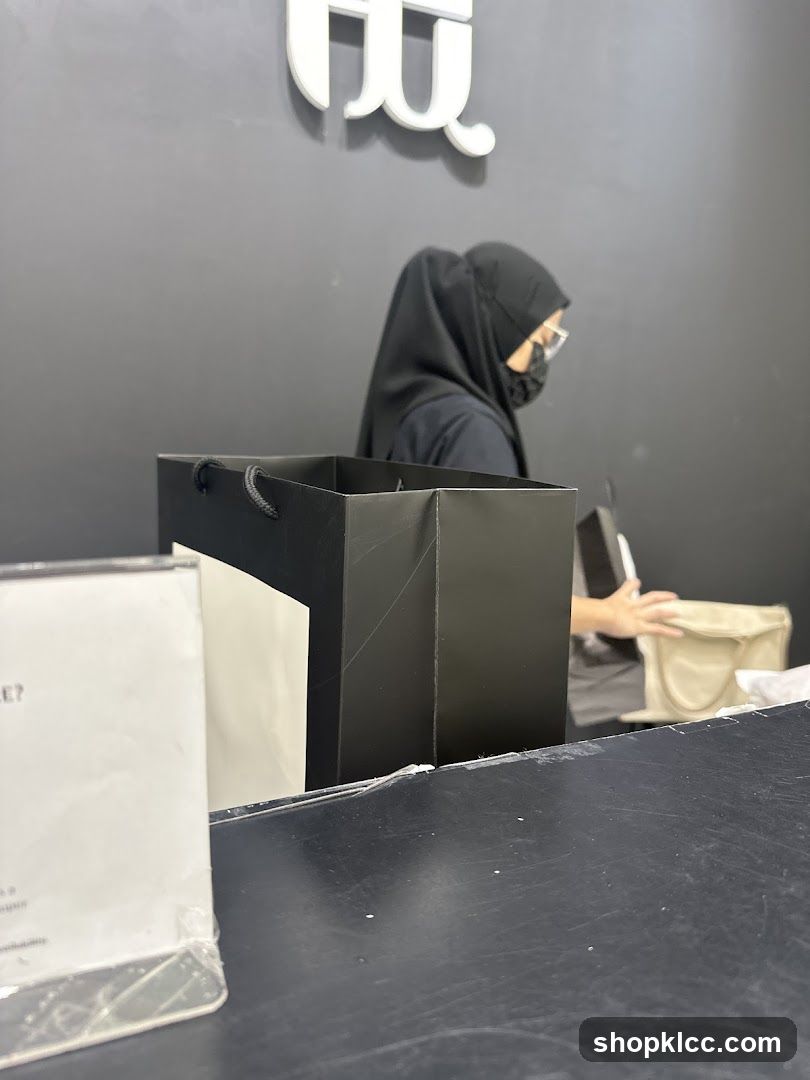 Shopping bags and a person at a counter