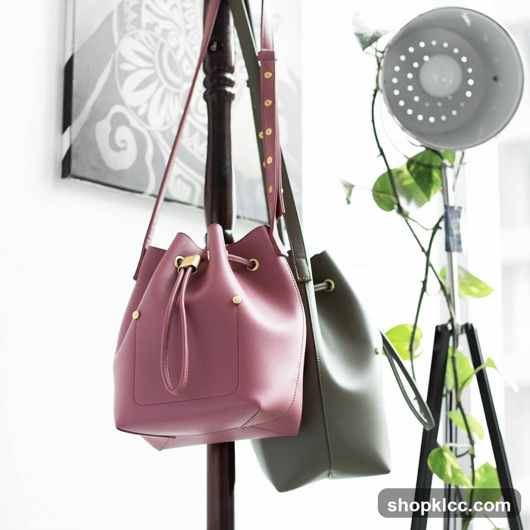 Two bucket bags hanging on a rack