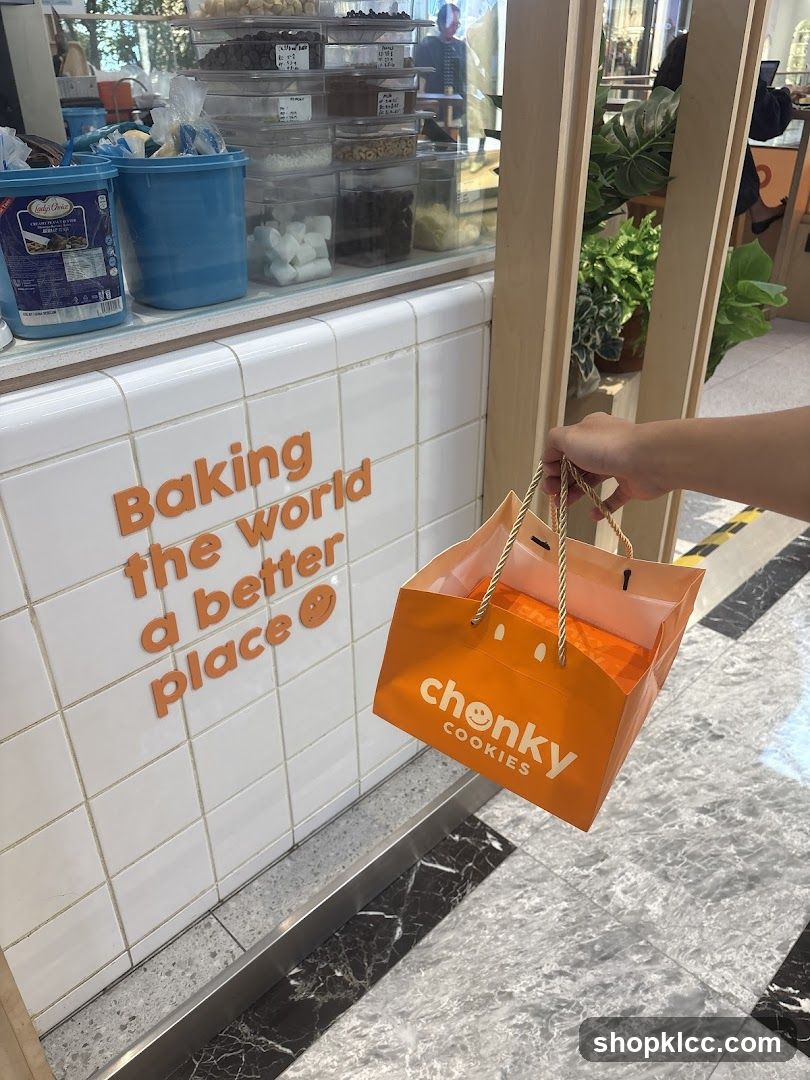 Person holding a shopping bag with cookies