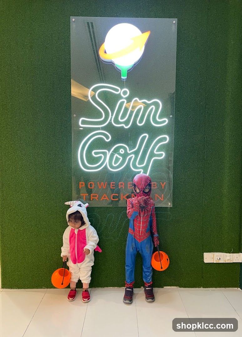 Kids in costumes at Sim Golf entrance