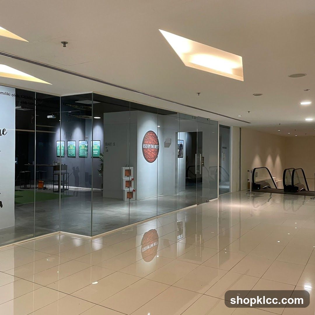 Interior of a modern commercial space with glass-walled shops and escalators