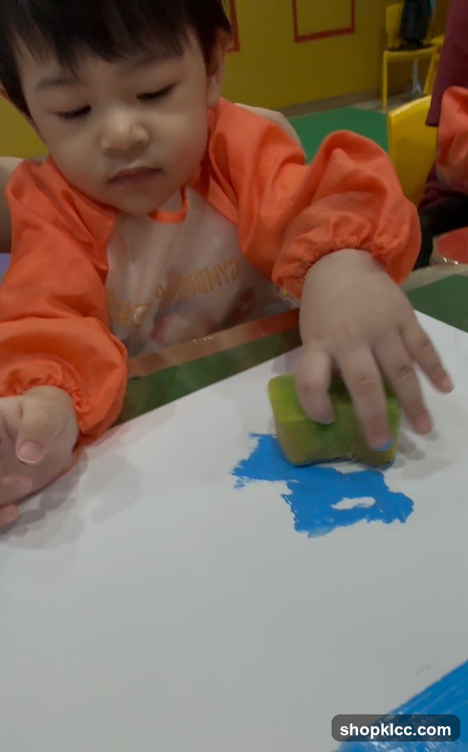 Child Painting with Sponge