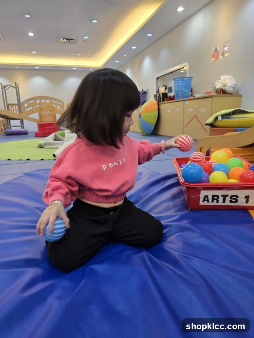 Child Playing with Balls in Playroom