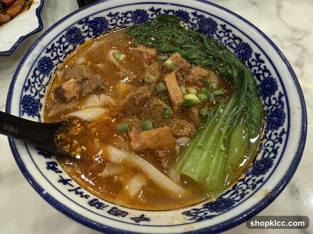 Bowl of Noodle Soup with Meat and Greens