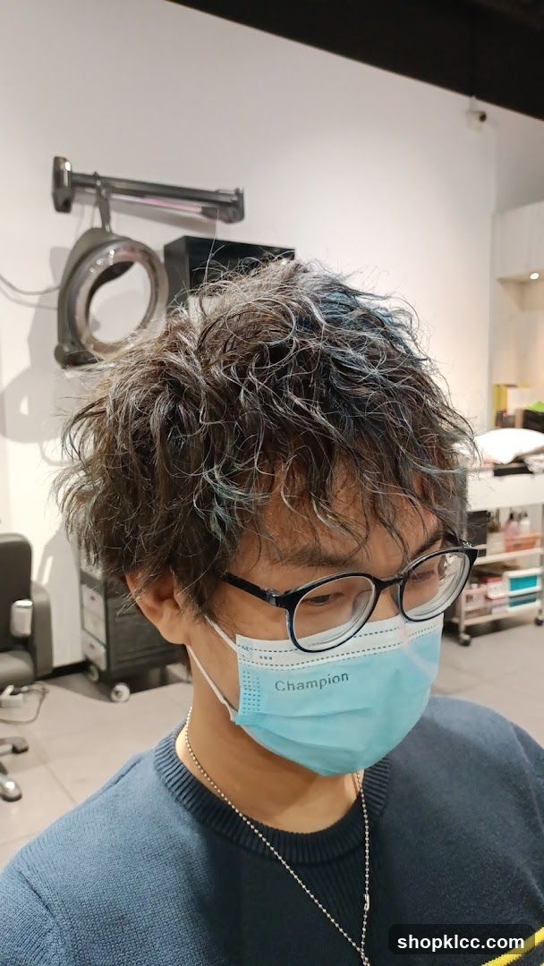 Person with mask and glasses in salon interior
