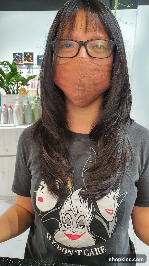 Person with long hair and mask in a salon