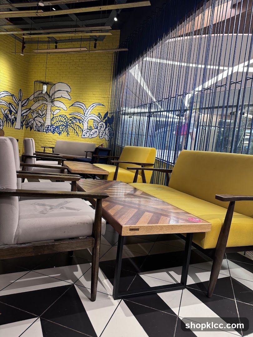 Modern cafe interior with yellow seating and tropical mural