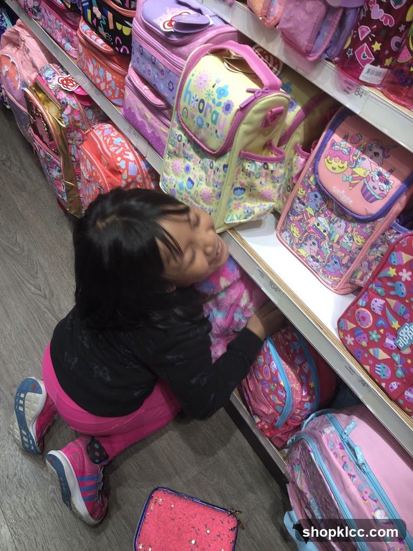 Girl Looking at Backpacks