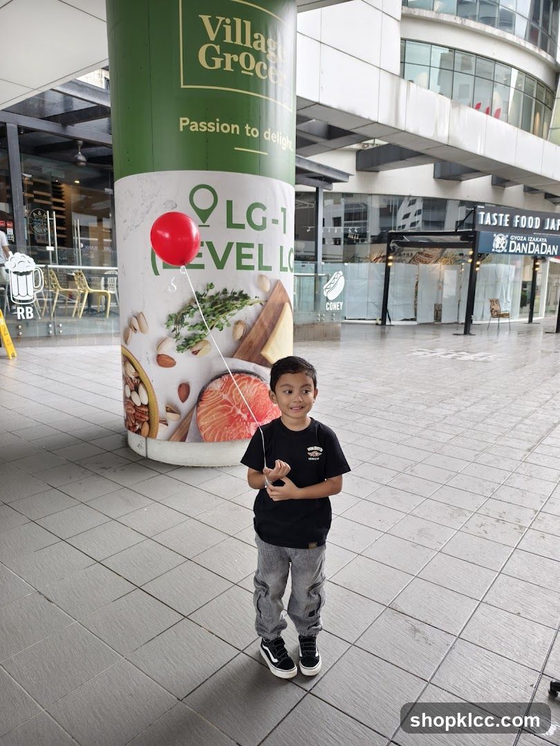 Boy with red balloon in mall