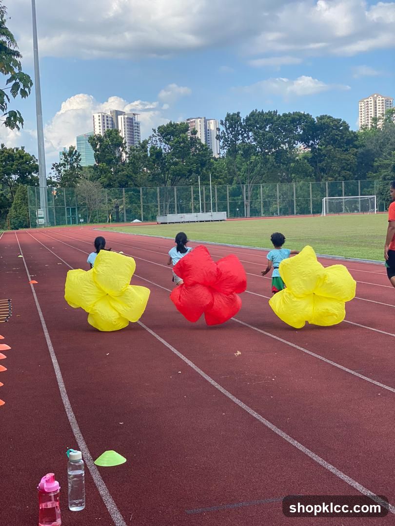 Children Running with Inflatable Flowers on Track