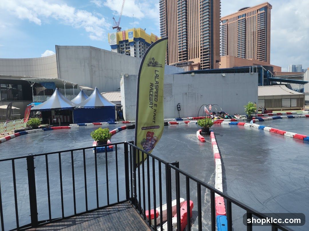 Go-kart track with tents and buildings in the background