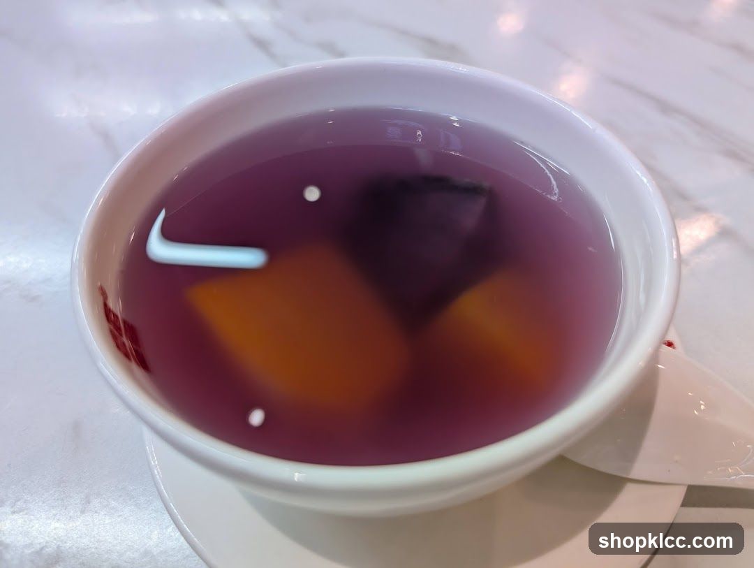 Bowl of Purple Soup with Fruit Pieces