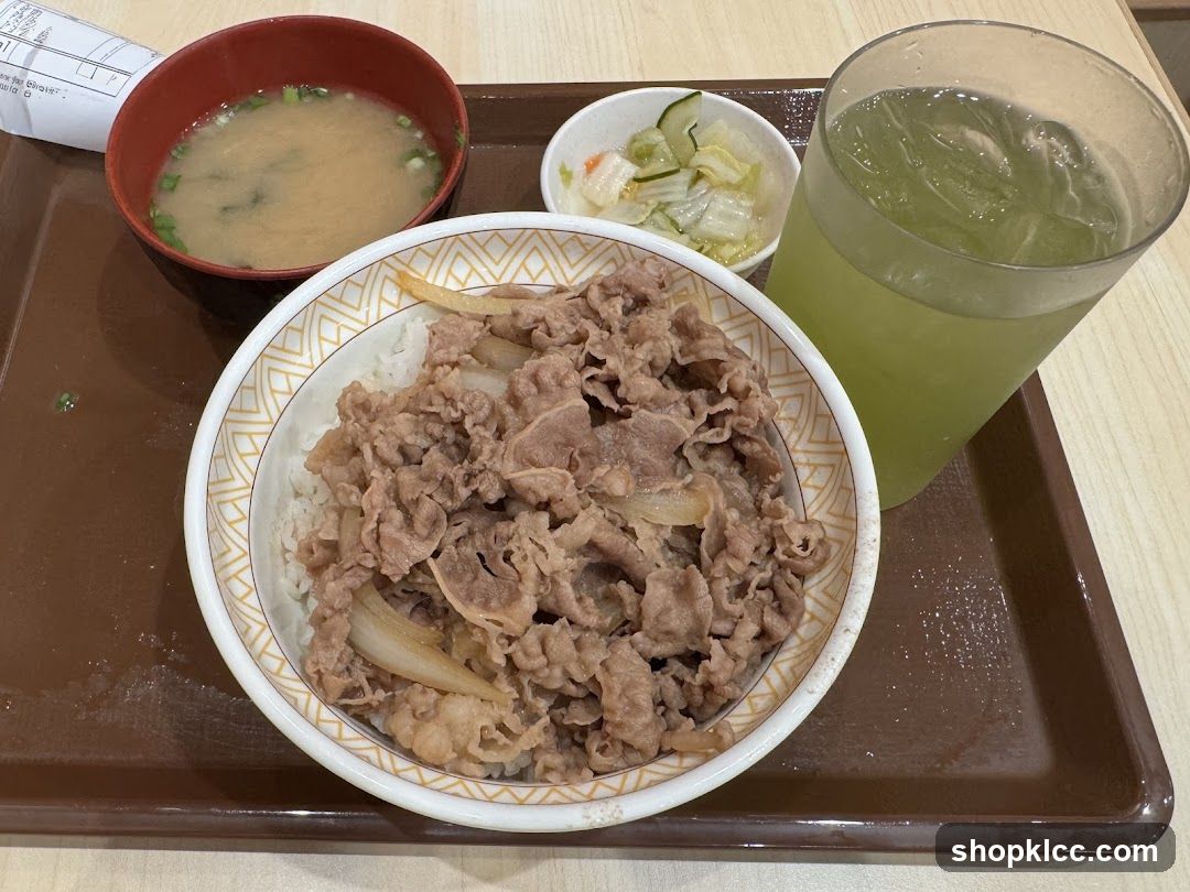 Bowl of Beef Rice with Side Dishes and Drink