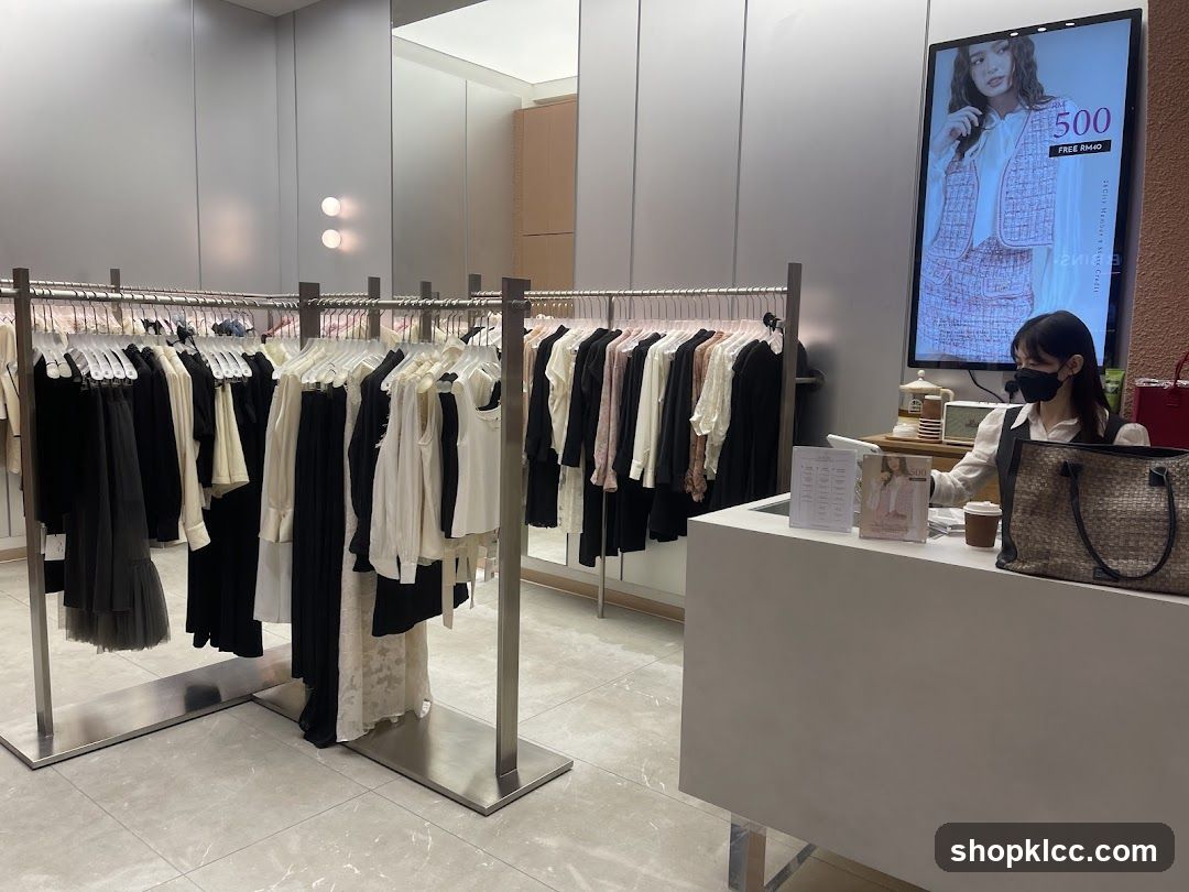 Clothing store interior with racks of clothes and a cashier