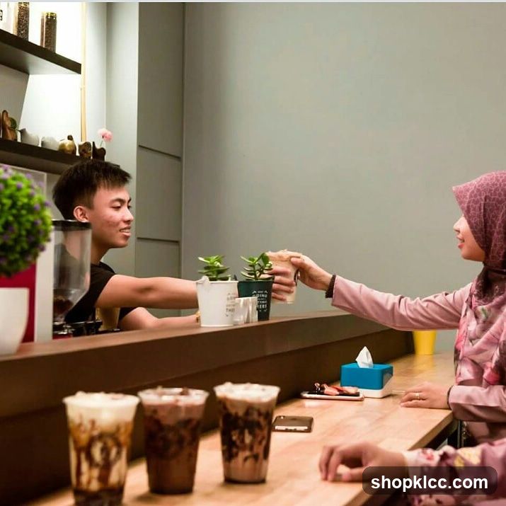 Barista Handing Coffee to Customer
