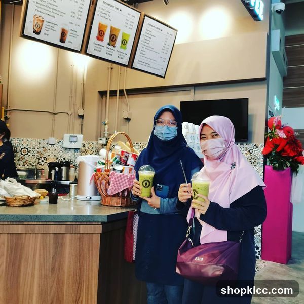 Customers with Green Smoothies at a Cafe
