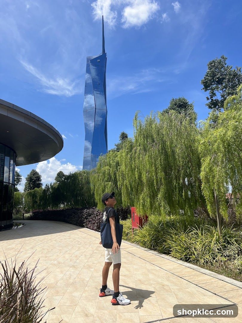 Boy looking up at a modern skyscraper