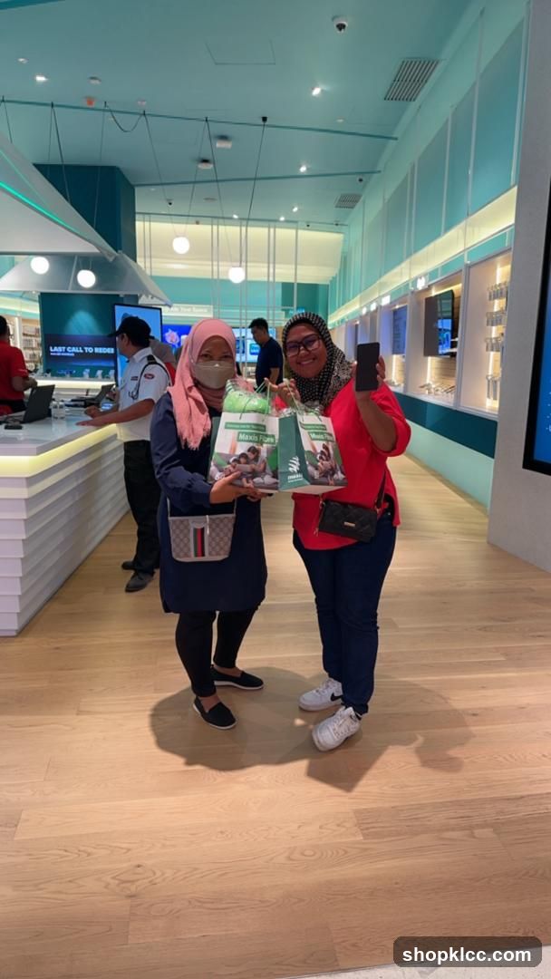 Two women holding shopping bags and a phone