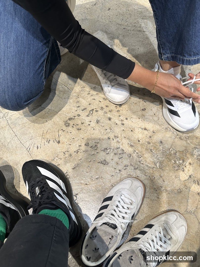 People trying on Adidas shoes