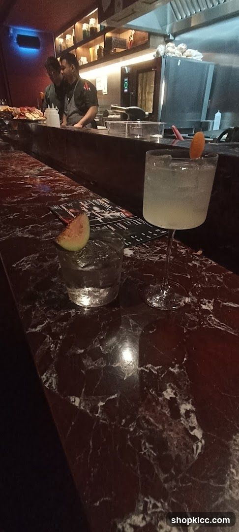 Bar Counter with Drinks and Staff