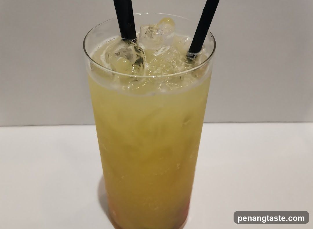 Yellow Cocktail with Ice and Straws